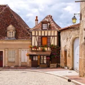 Quaint street in a town in Burgundy, France with small timbered house
