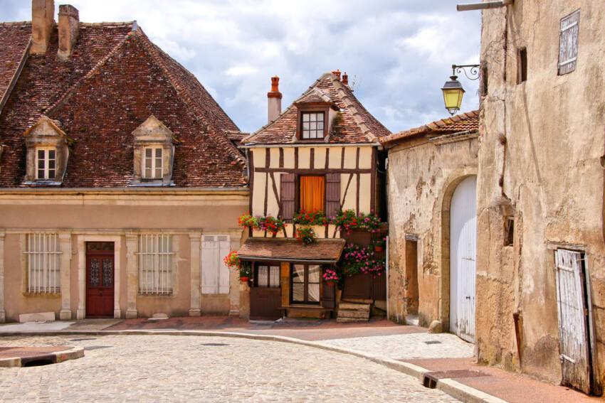 Quaint street in a town in Burgundy, France with small timbered Quaint street in a town in Burgundy, France with small timbered house
